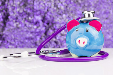 Piggy bank with a stethoscope: health insurance
