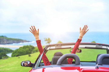 Girl in a red convertible car. - obrazy, fototapety, plakaty