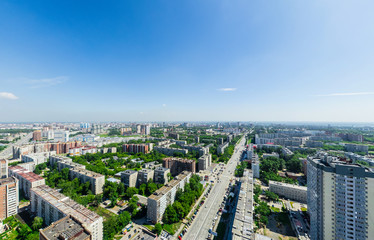 Fototapeta na wymiar Aerial city view with crossroads and roads, houses, buildings, parks and parking lots, bridges. Urban landscape. Copter shot. Panoramic image.