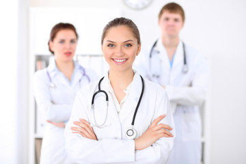 Fototapeta premium Happy doctor woman with medical staff at the hospital