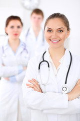 Happy doctor woman  with medical staff at the hospital