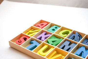 Colorful wooden letter with white background
