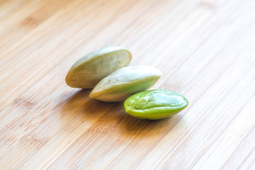 Parkia speciosa ( petai, bitter bean, twisted cluster bean, stinker or stink bean) with white cup and spoon