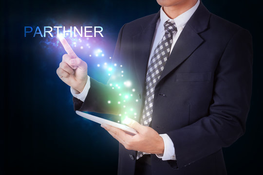 Businessman holding tablet with pressing parthner. internet and networking concept