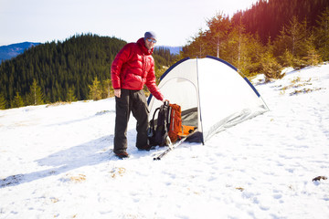 Climber with a backpack near the tent.