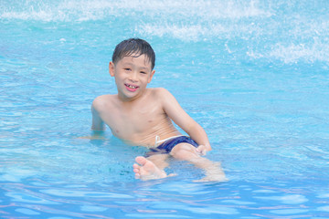 Fototapeta na wymiar Young asian boy happy at swimming pool