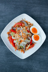 Green Papaya Salad (Som tum Thai) mixed with seafood and boil eg