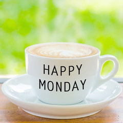 Happy Monday on coffee cup with nature background
