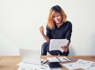 A happy and successful business woman with her work.