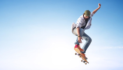 Naklejka na ściany i meble Skater on the sky background. Sport and active life concept