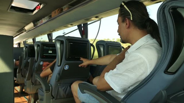 Man watching tv on the bus