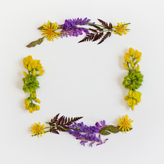 Wreath frame with delicate wildflowers. Place for text. Top view