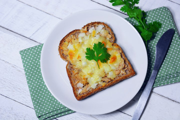 tuna bread and cheese melt on top for breakfast