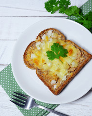 tuna bread and cheese melt on top for breakfast