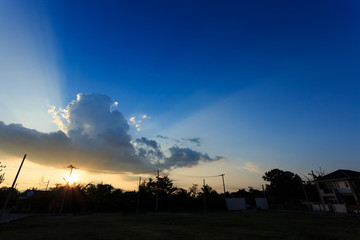 beautiful sunset sky with sunlight through cloudy