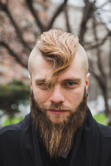 Stylish bearded man posing in the street