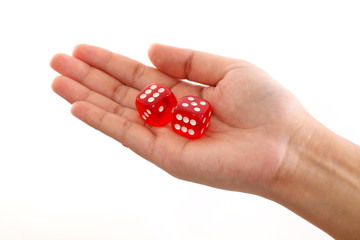 Hand holding red dice against white background