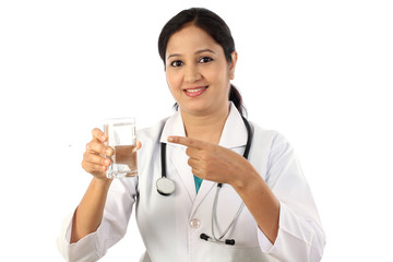 Happy young female doctor with a glass of water - 114892829