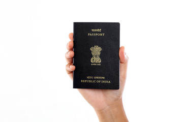 Hand holding Indian passport against white background - 114893043