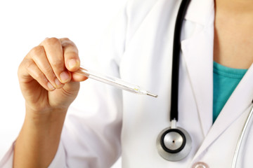 Young female doctor checking fever using thermometer