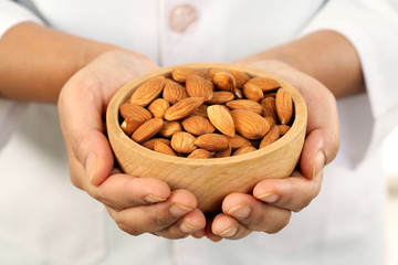 Doctor holding a bowl of almonds - Health concept - 114893270