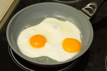 Frying pan with cooked two eggs 