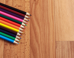 Colored pencils on a wooden board
