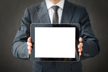 Business man holding blank screen tablet