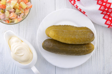 Pickled cucumber with mayonnaise and salad olivie. Russian style.