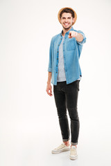 Fototapeta premium Full length portrait of a man pointing finger at camera