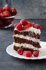 Naked cake with cream, decorated with raspberries, blackberries.