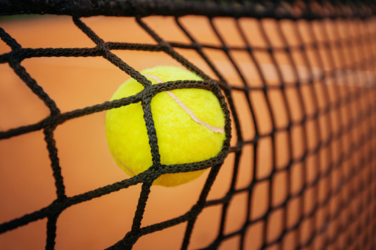 Tennis ball hitting the net