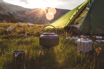 Camping in the mountains at morning. - obrazy, fototapety, plakaty