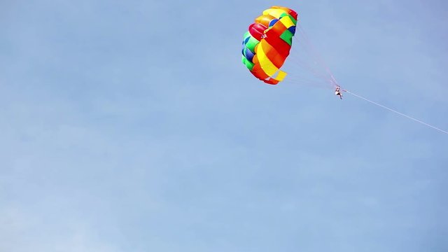 Parachute hauled by the motorboat flying in the sky