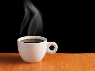 White Cup of hot black coffee on table with black background