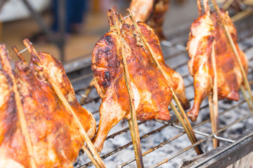 Hot roasting chicken on grill barbecue