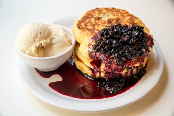 Freshly homemade desserts pancakes with vanilla icecream and blu