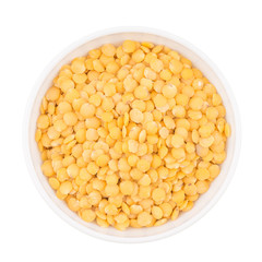 Bowl of yellow split lentil isolated on white background, top vi