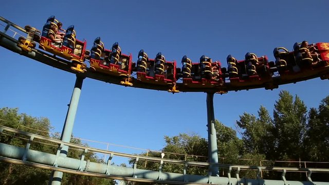 Rollercoaster train is moving along the loop, train gyrates
