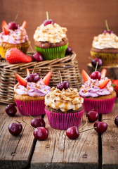 Delicious cupcakes decorated with caramel and fresh berries