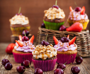 Delicious cupcakes decorated with caramel and fresh berries