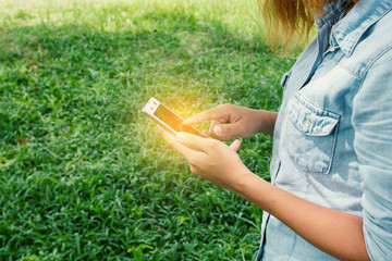 Young hipster woman taping in cell phone.