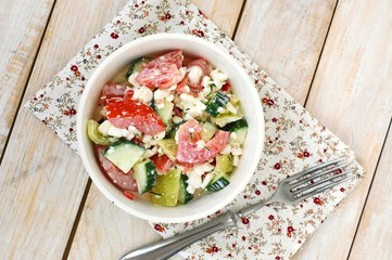 Healthy fresh salad from vegetable, tomatoes, cucumber, green pepper, cottage cheese, chives and olive oil