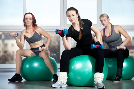 Exercising with dumbbells on balls