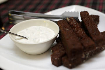 Plate with garlic croutons and sauce