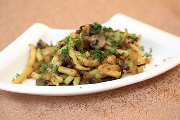 Plate with fried potatoes and mushrooms