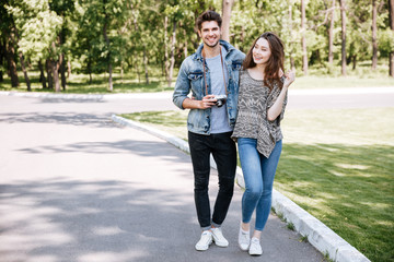 Portrait of a young couple walking in park