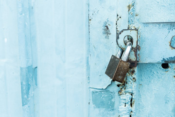 Closeup metal door with lock in grungy style and good texture
