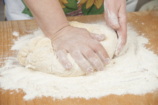 Women's hands preparing fresh yeast dough