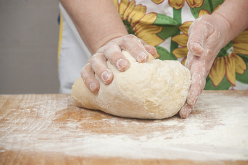 Women's hands preparing fresh yeast dough